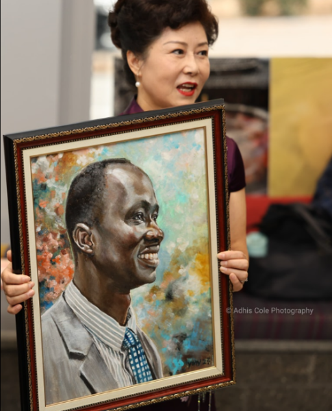 80-year-old artist Yunin Yang with her delightful portrait of Beny Bol.