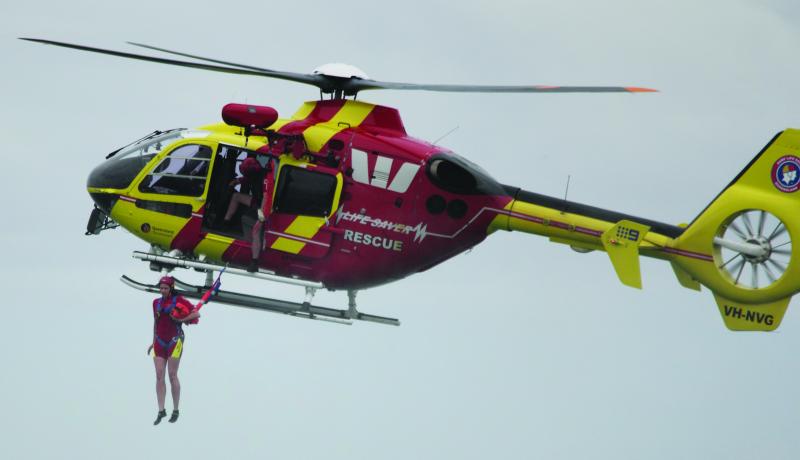 Fiona McLarty (today Fiona Sessarago), a Nobbys patrolling member and Westpac Surf Rescue chopper crewie, exists the aircraft at Nobbys in a rescue demonstration.