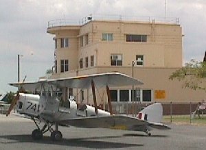 Archerfield airport Terminal in 1995, accessorised by a de Havilland Tiger Moth.